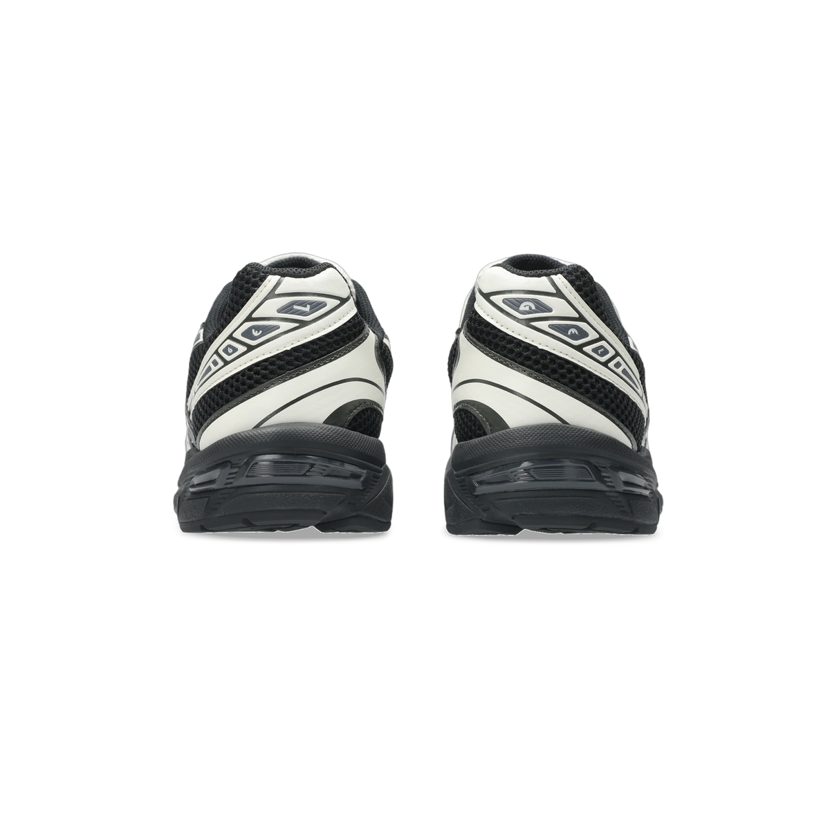 Rear view of a pair of black and white Asics Gel-1130 sneakers showing the heel counters, mesh panels, and thick black midsoles.