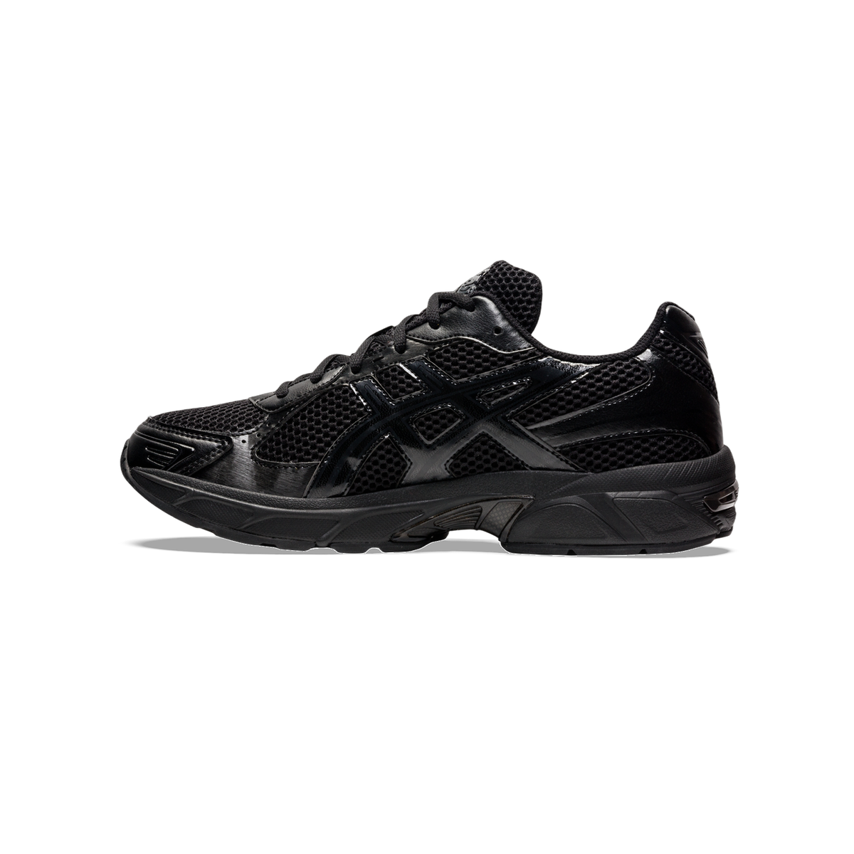 Side view of an all-black Asics Gel-1130 sneaker with mesh panels and a chunky black midsole.