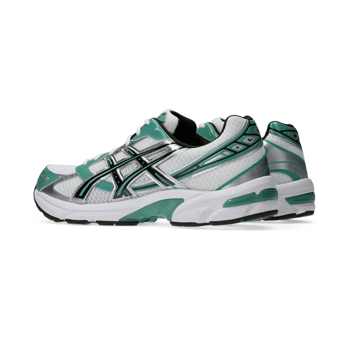 Side view of a white and green Asics Gel-1130 running shoe with silver and black accents, shown with a second shoe partially visible behind it