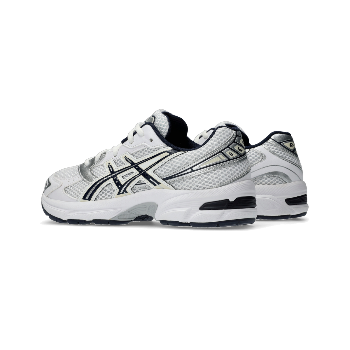 Pair of white Asics Gel-1130 sneakers with navy and silver accents, shown from the side with mesh uppers and white midsoles.