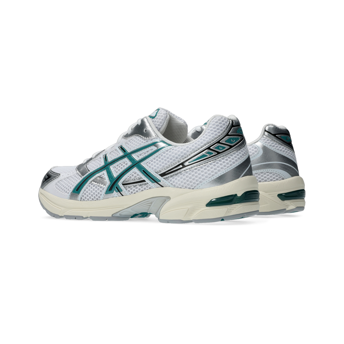 Side view of a pair of white Asics Gel-1130 sneakers with teal overlays, silver accents, and an off-white midsole with a translucent gel unit at the heel.