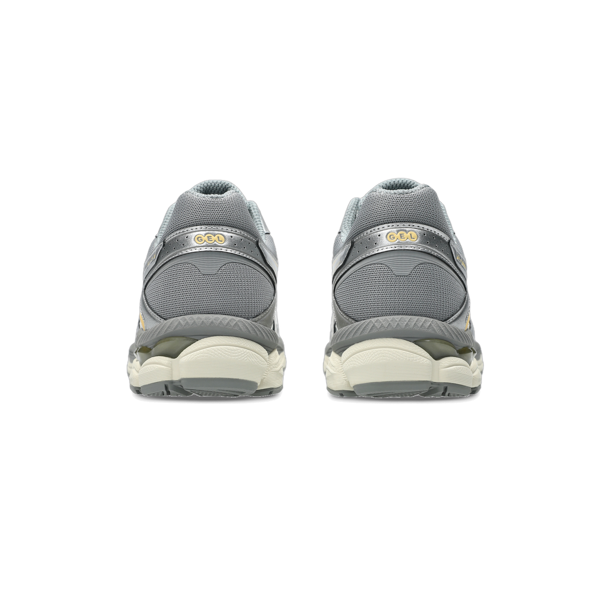 Rear view of a pair of grey Asics Gel-Cumulus sneakers with cream midsoles and gold GEL branding on the heel
