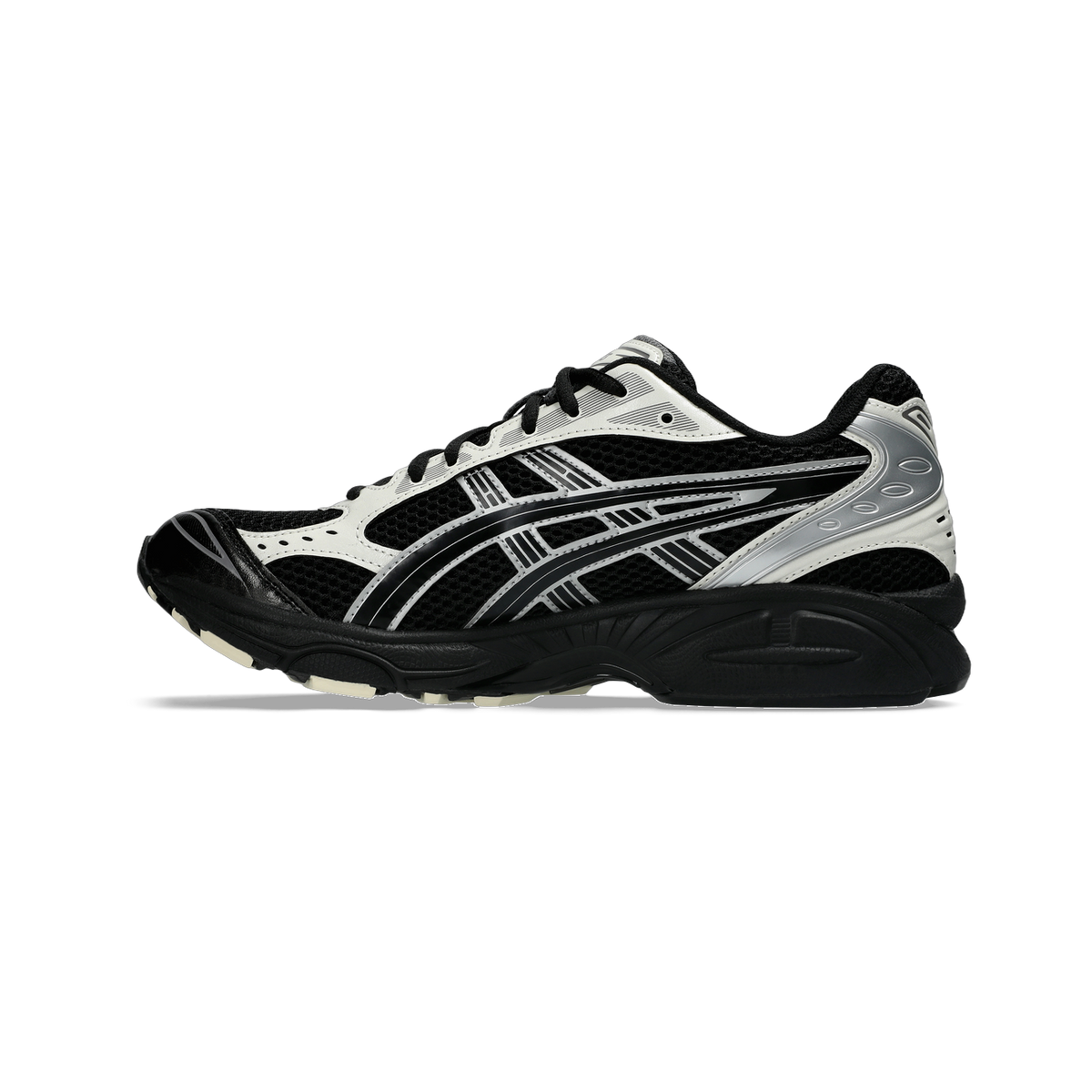 Lateral view of a black and white Asics Gel-Kayano 14 running shoe with silver overlays and a black outsole.
