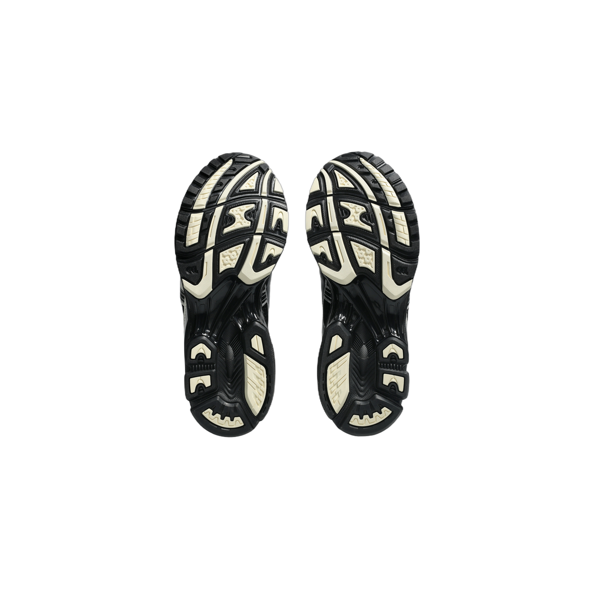 Bottom view of a pair of Asics Gel-Kayano 14 sneakers showing black and cream tread patterns on the outsoles