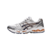 Right-side view of a white and silver ASICS Gel-Kayano 14 sneaker with navy blue overlays and peach accents on the midsole, toe pointing left.