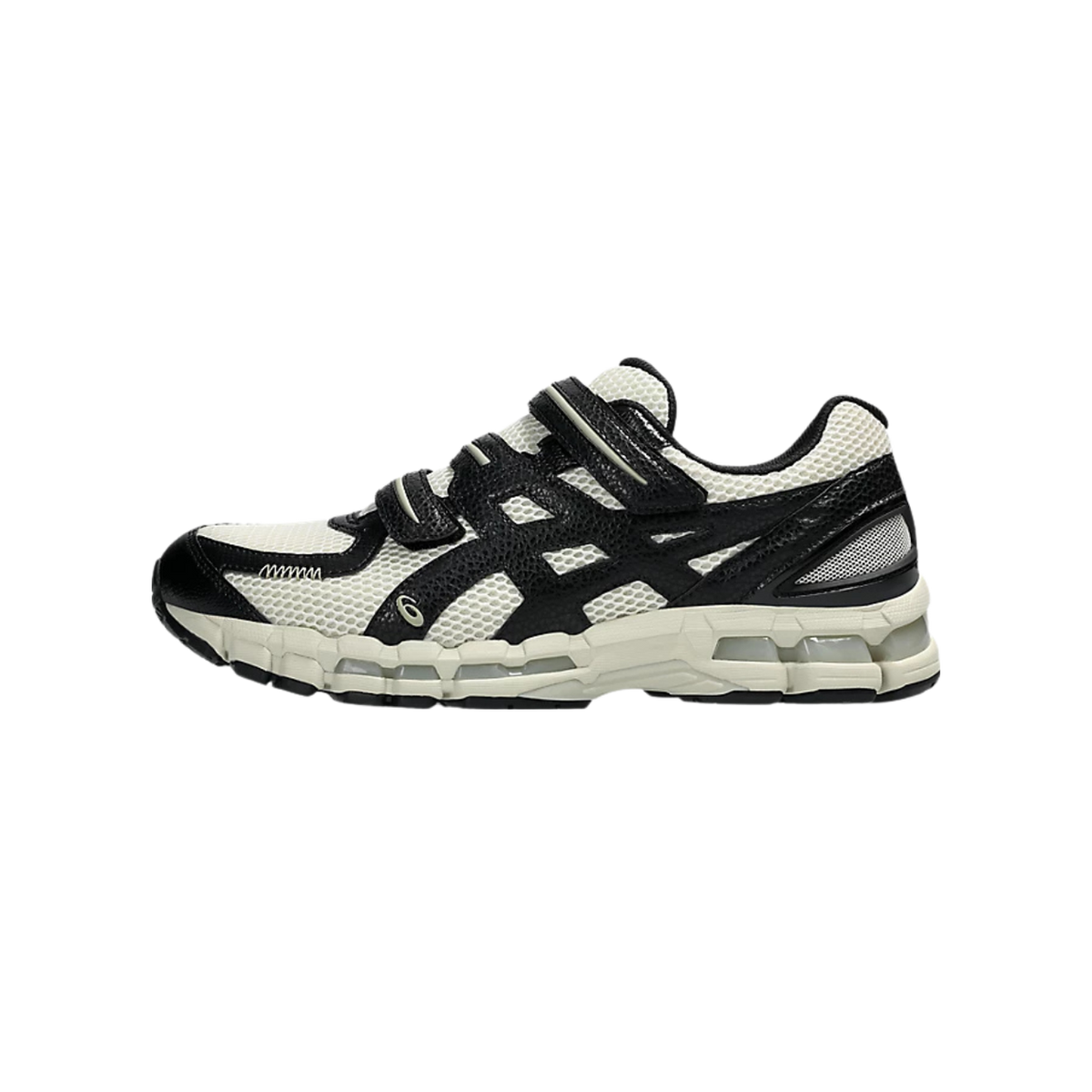 Side view of a white and black Asics Gel-Kayano 20 sneaker with toe pointing left, featuring mesh upper, black overlays, strap detailing, and a cream midsole.
