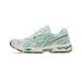 Side view of a white and green Asics Gel-NYC 2055 sneaker with silver overlays and a visible green gel cushioning unit in the heel and forefoot.