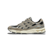 Side view of a black, gray, and beige Asics Gel-NYC sneaker with a chunky cream midsole and the toe pointing left.