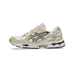 Side view of a white and tan Asics Gel-NYC sneaker with brown zigzag overlays and a translucent brown heel gel unit.