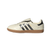 Side view of a cream white Adidas Samba sneaker with black three stripes, black heel tab, gum outsole, and toe pointing left
