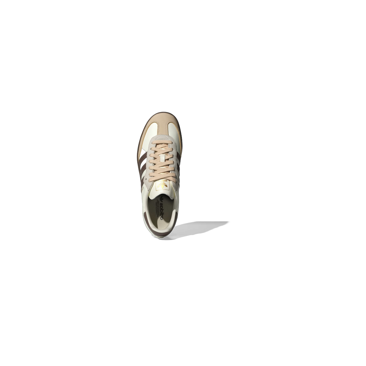 Top-down view of a white Adidas Samba OG sneaker with brown three stripes, tan heel and toe accents, and beige laces, showing the branded insole