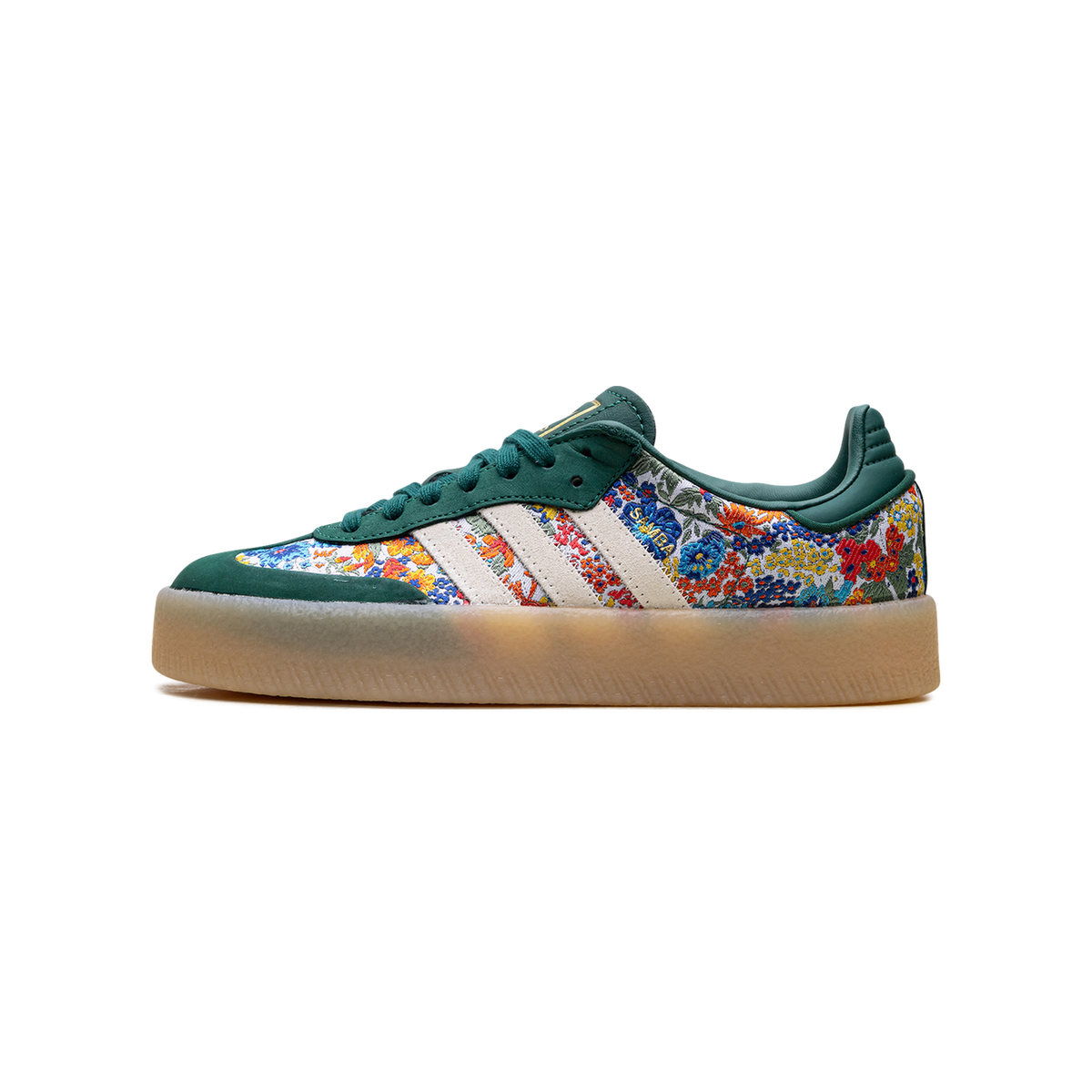 Left side view of a green Adidas Sambae sneaker with floral Liberty London print, cream stripes, and a translucent gum platform sole, toe pointing left.