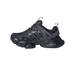 Left Adidas XLG Runner Deluxe sneaker in black and grey, shown from the side with toe pointing left, displaying chunky lugged sole and three-stripe branding.