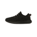 Side view of a black Adidas Yeezy Boost 350 sneaker with toe pointing left, showing textured knit upper, black laces, and a ridged boost midsole with a red stitched pull tab at the heel.
