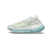 Side profile of a single white and pale-green knit adidas Yeezy Boost 380 sneaker with a teal-blue translucent midsole, toe pointing left, with grey speckled pattern on the upper and a light green overlay stripe.