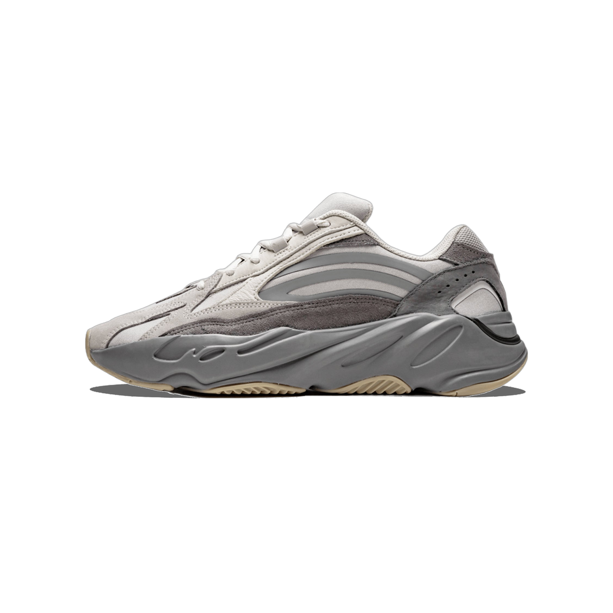 Side view of a grey Adidas Yeezy Boost 700 V2 sneaker with layered suede and mesh panels and a chunky grey midsole, toe pointing left.