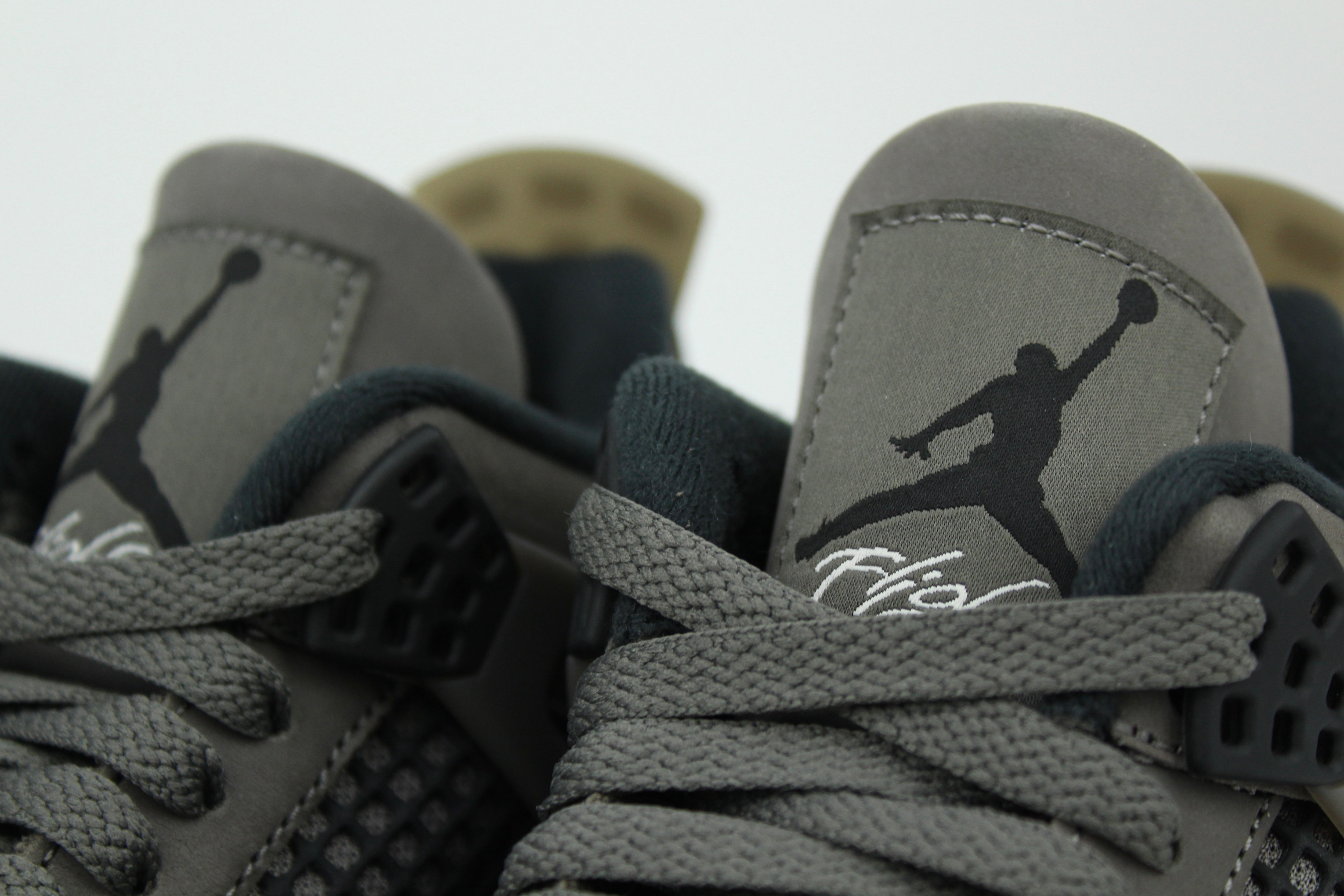 The Air Jordan 4 Cave Stone reimagines the classic silhouette with an earthy nubuck upper in taupe-brown tones, contrasted by bold black mesh and details. Travis Scott vibes.