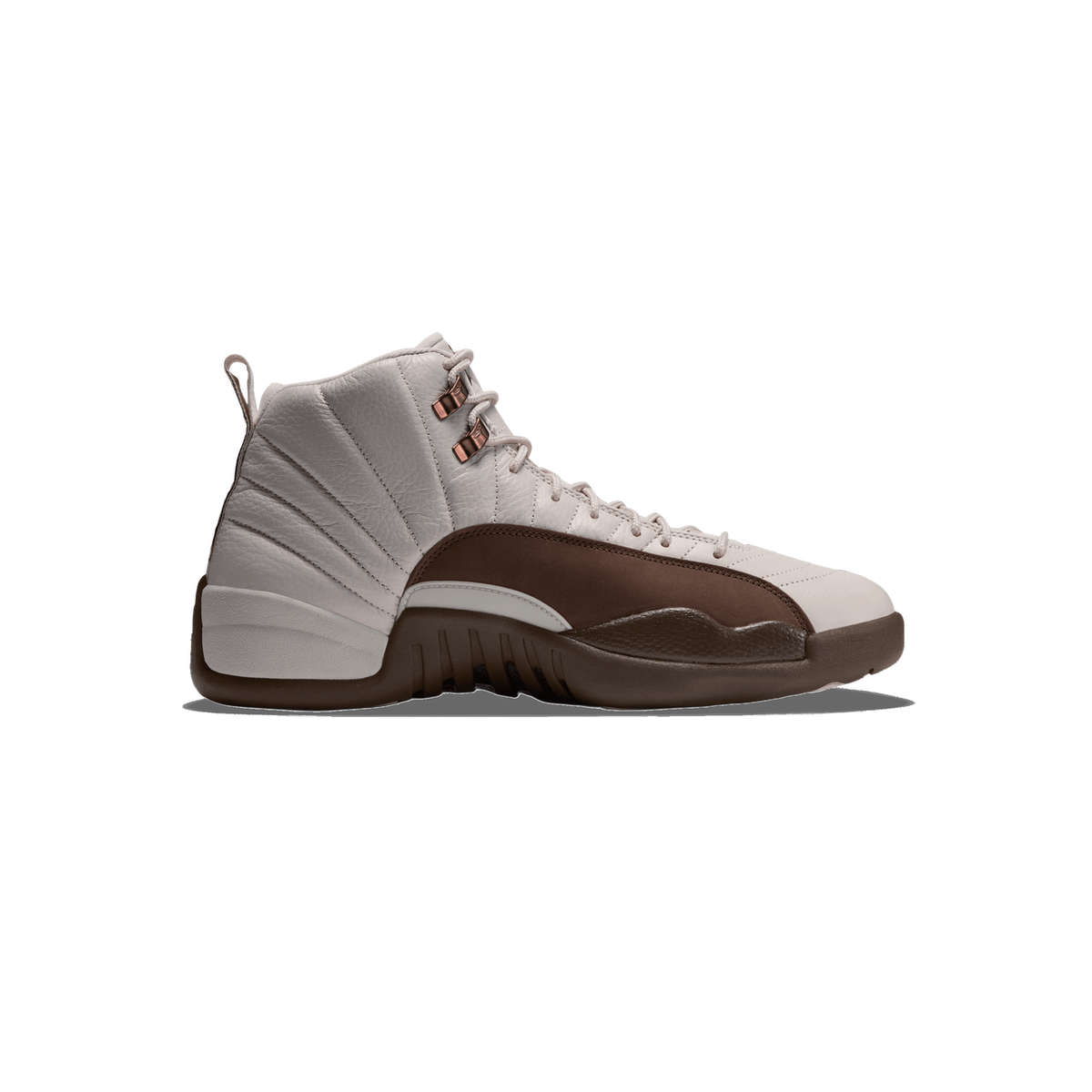 Side view of a light grey Air Jordan 12 high-top sneaker with a brown toe cap and midsole and copper-colored lace eyelets, toe pointing left