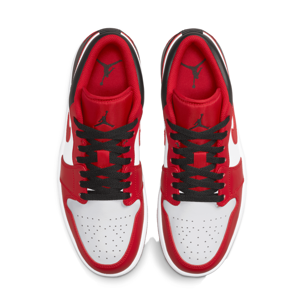 Top-down view of a pair of red, white, and black Air Jordan 1 Low sneakers placed side by side with toes pointing up, showing the black heel collars, black laces, and red tongues with Jordan Jumpman logos.