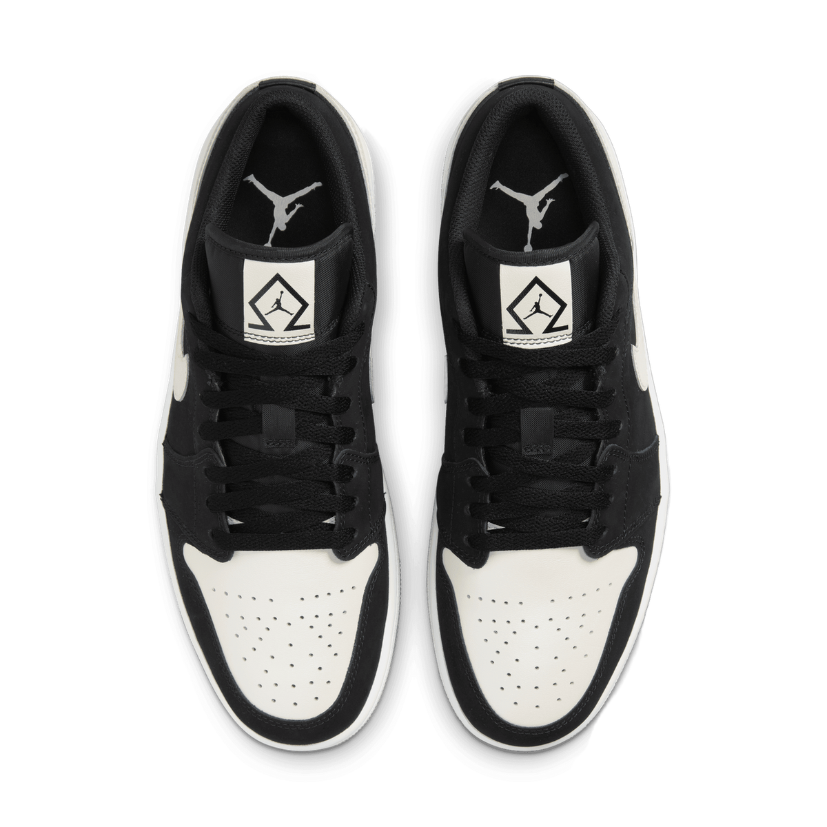 Top-down view of a pair of black and white Jordan 1 Low sneakers with Jumpman logo on the tongue and a diamond-shaped tag featuring the Jumpman graphic.
