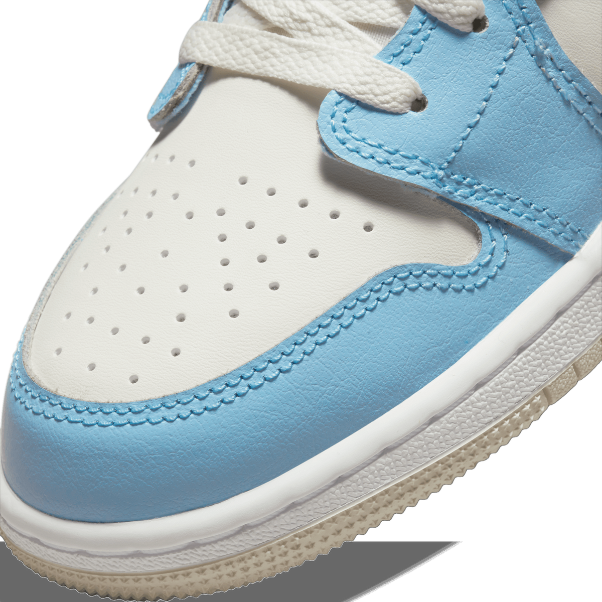 Close-up of the toe box of a white and ice blue Jordan 1 Low showing perforated leather, stitching detail, and white laces.