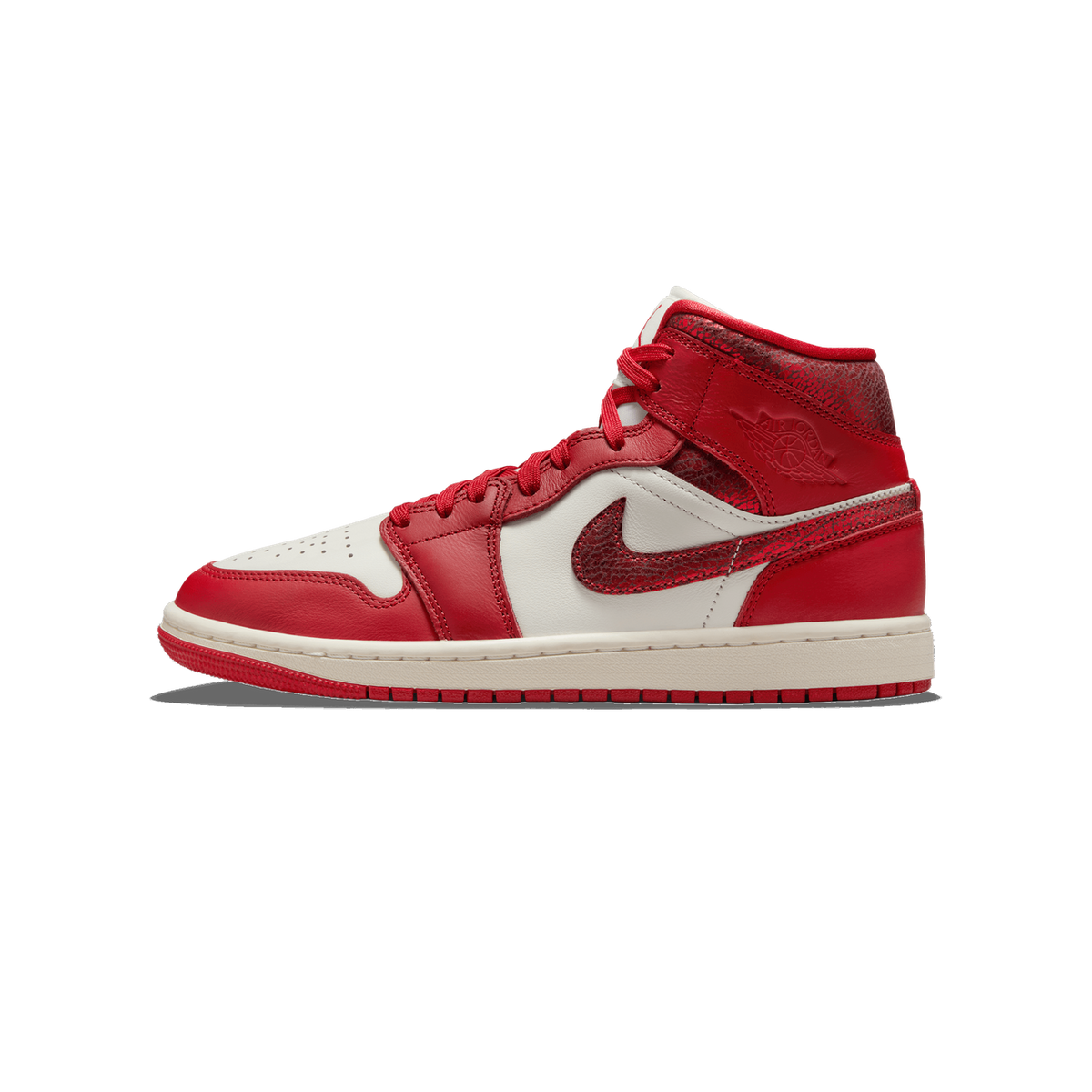 Lateral view of a red and white Air Jordan 1 Mid sneaker with cracked-texture leather panels on the heel and swoosh, red laces, and white midsole with red outsole.