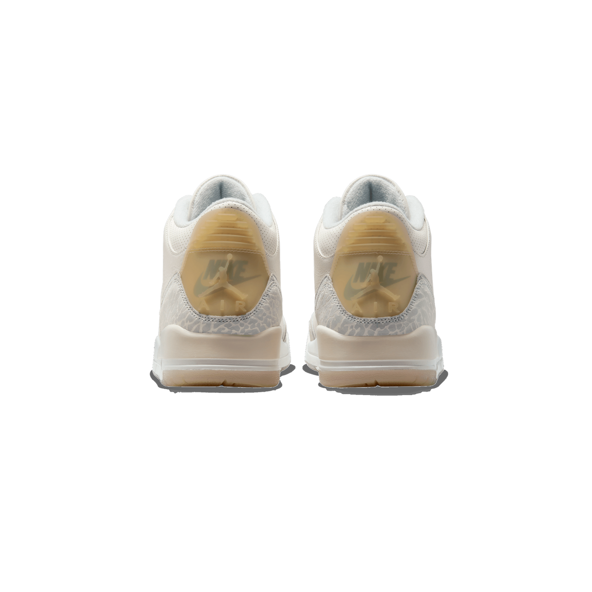 Rear view of a pair of white Jordan 3 Retro Craft Ivory sneakers showing the Jumpman heel tabs and elephant print detailing