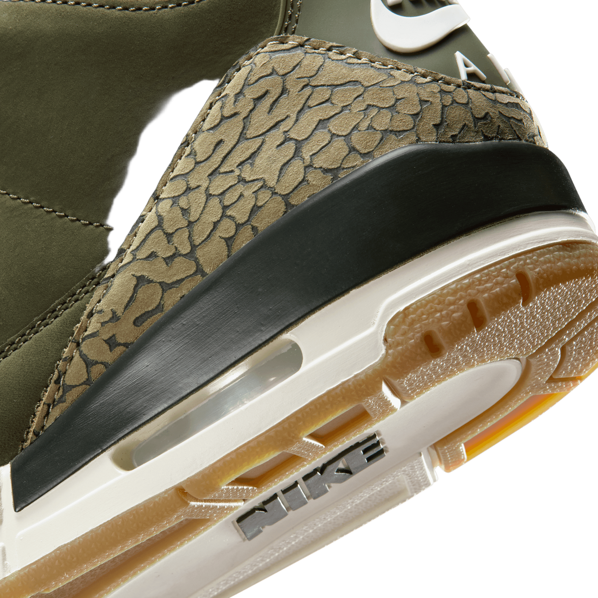 Close-up of an Air Jordan 3 heel showing olive green leather, tan elephant print texture, black heel tab, and white midsole with Nike branding and gum outsole.