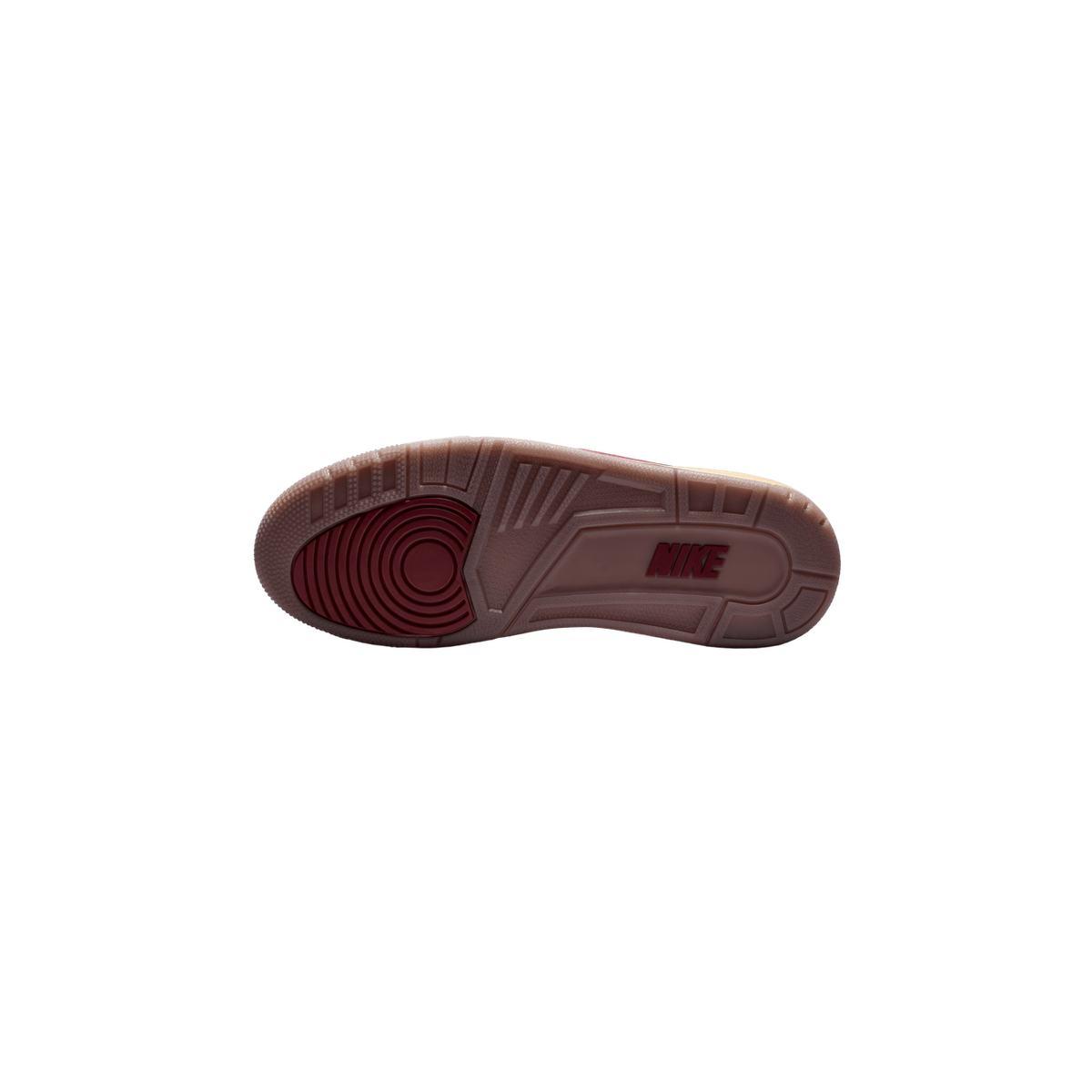 Underside of a sneaker showing a dark red rubber outsole with a concentric circle traction pattern at the heel, a brown midsole with the word NIKE embossed in dark red, and a pale yellowish upper edge visible at the side.