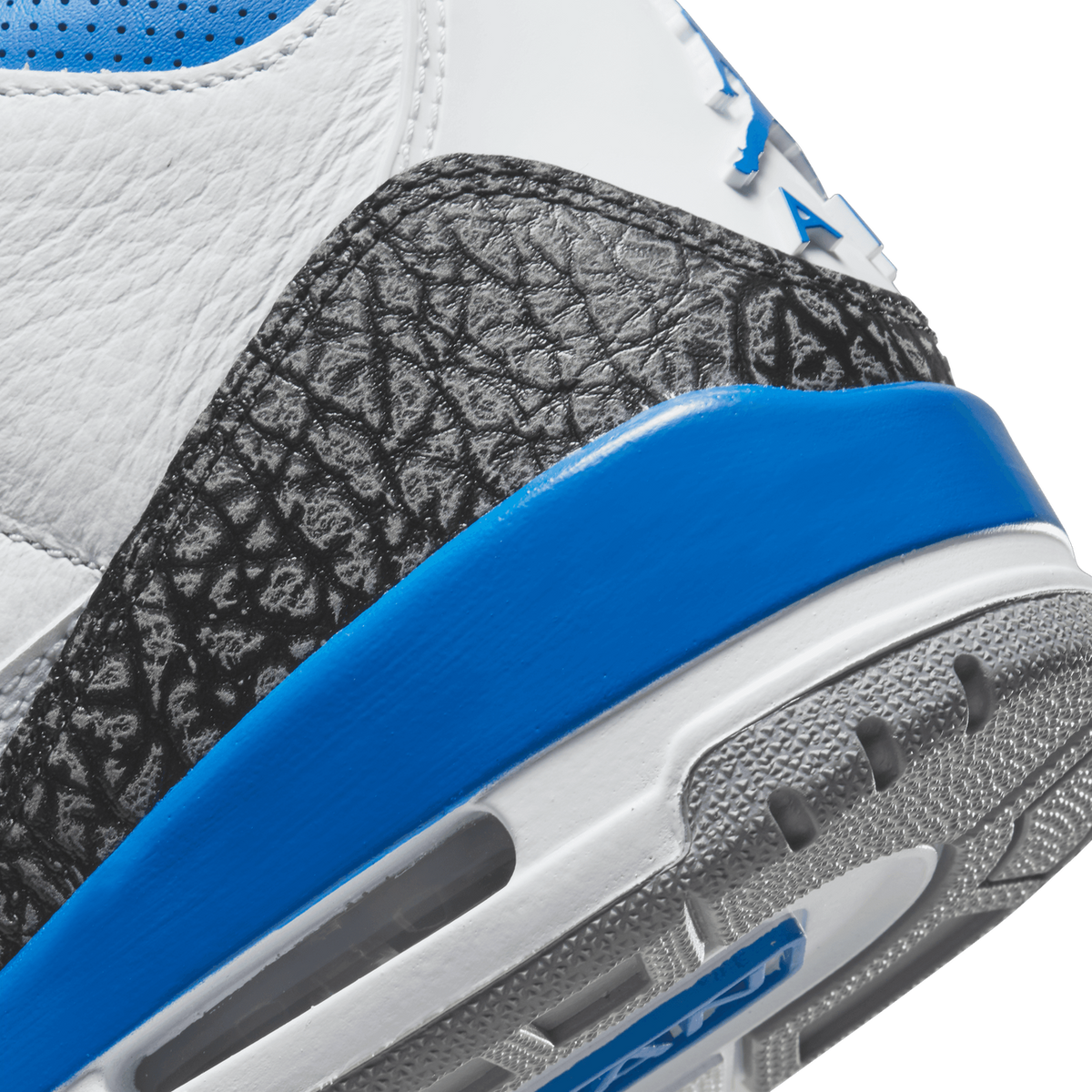 Close-up of the Jordan 3 Retro's elephant print toe cap, blue midsole band, and white textured outsole.