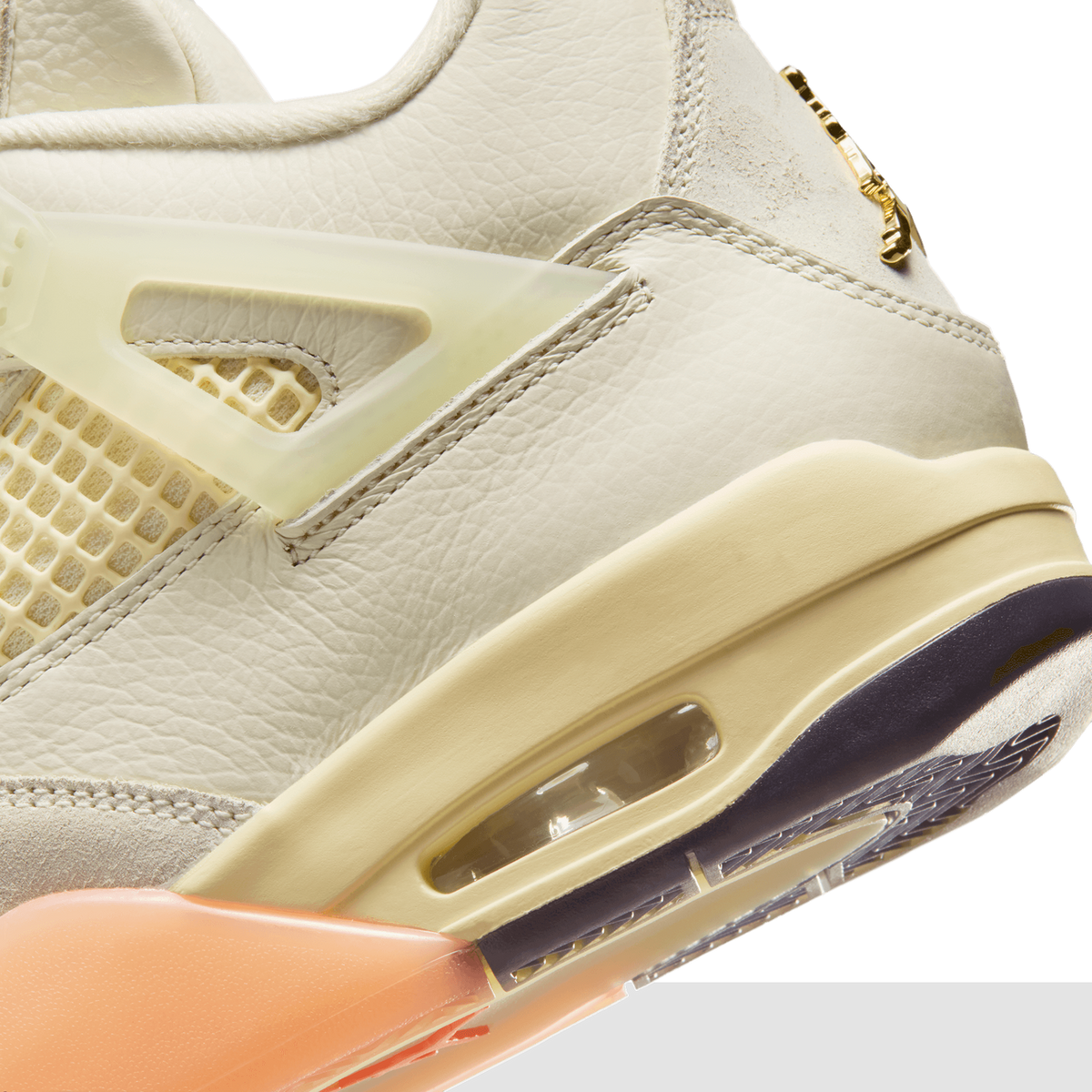 Close-up of the Air Jordan 4 Birds of Paradise showing the translucent mesh eyelet wing, cream leather upper, visible Air unit, and peach-colored midsole detail.