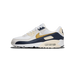 Side view of a white Nike Air Max 90 sneaker with navy overlays, gold Swoosh, visible heel air unit, and cream midsole, toe pointing left.