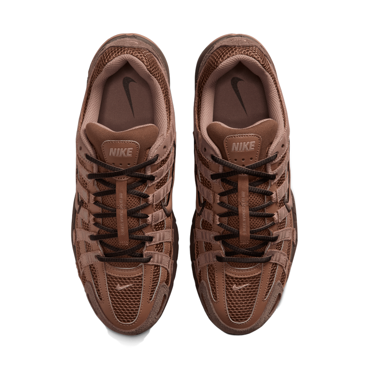 Top-down view of a pair of brown Nike P-6000 sneakers placed side by side, showing the mesh and suede uppers, dark brown laces, tongue labels reading NIKE, and the insoles with embossed Swoosh logos.