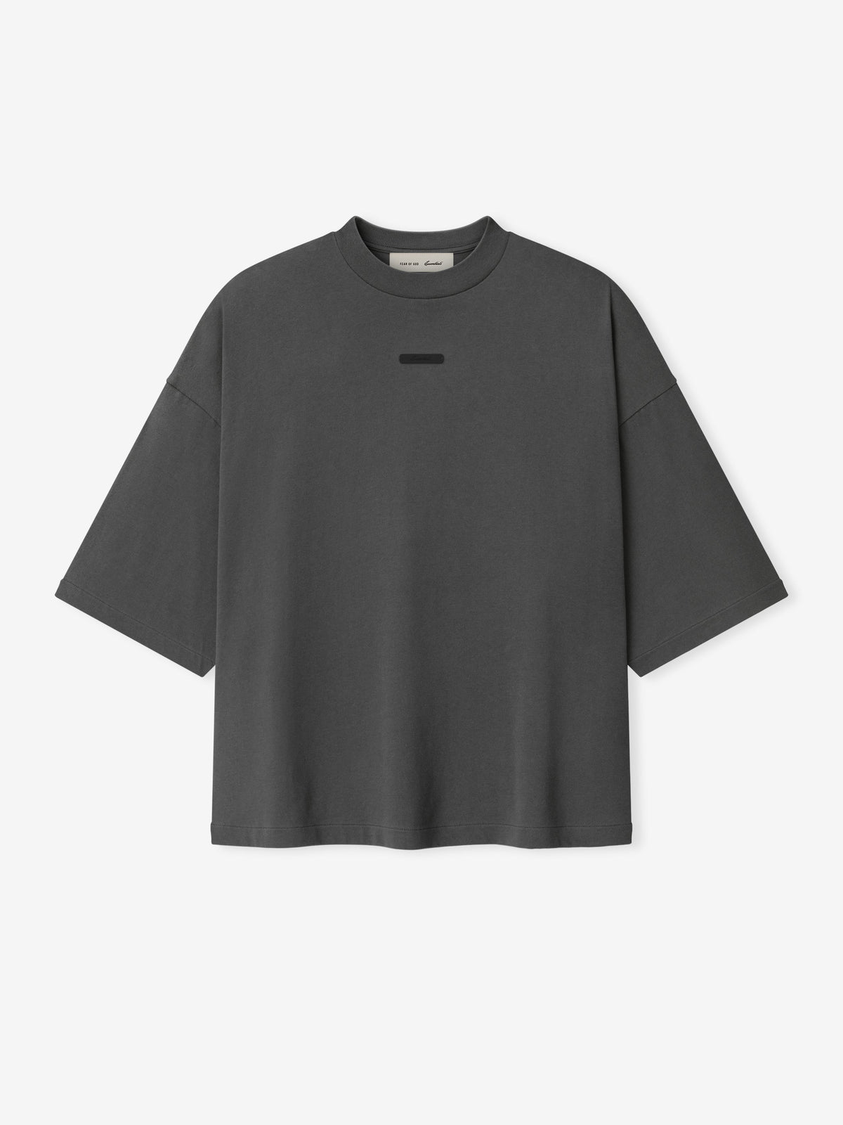Front view of a gray oversized Fear of God Essentials T-shirt with a small rectangular tonal logo patch at the chest and a visible neck label.