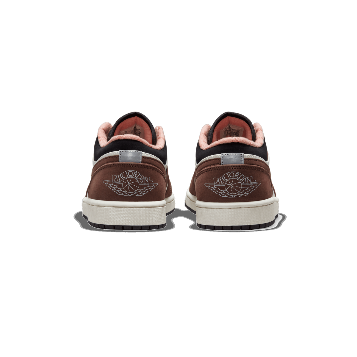 Rear view of a pair of brown, white, and black Air Jordan 1 Low sneakers showing the Wings logo and pink-lined heel collars