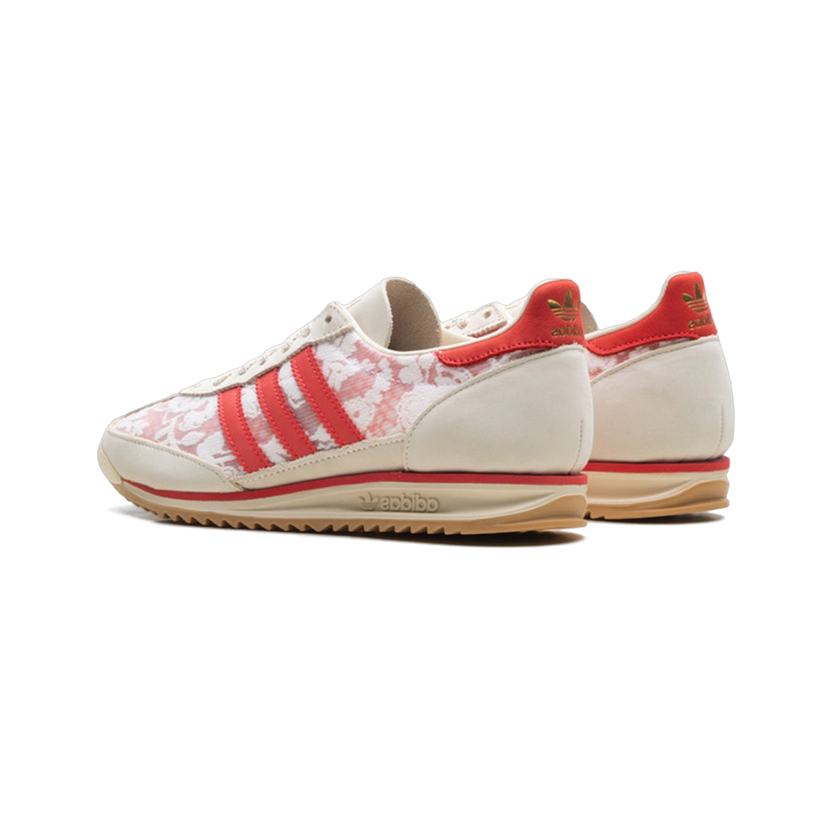 Rear angled view of a pair of Adidas SL 72 sneakers with white and pink floral print, red suede heel tabs with gold trefoil logos, red three stripes, and gum outsoles.