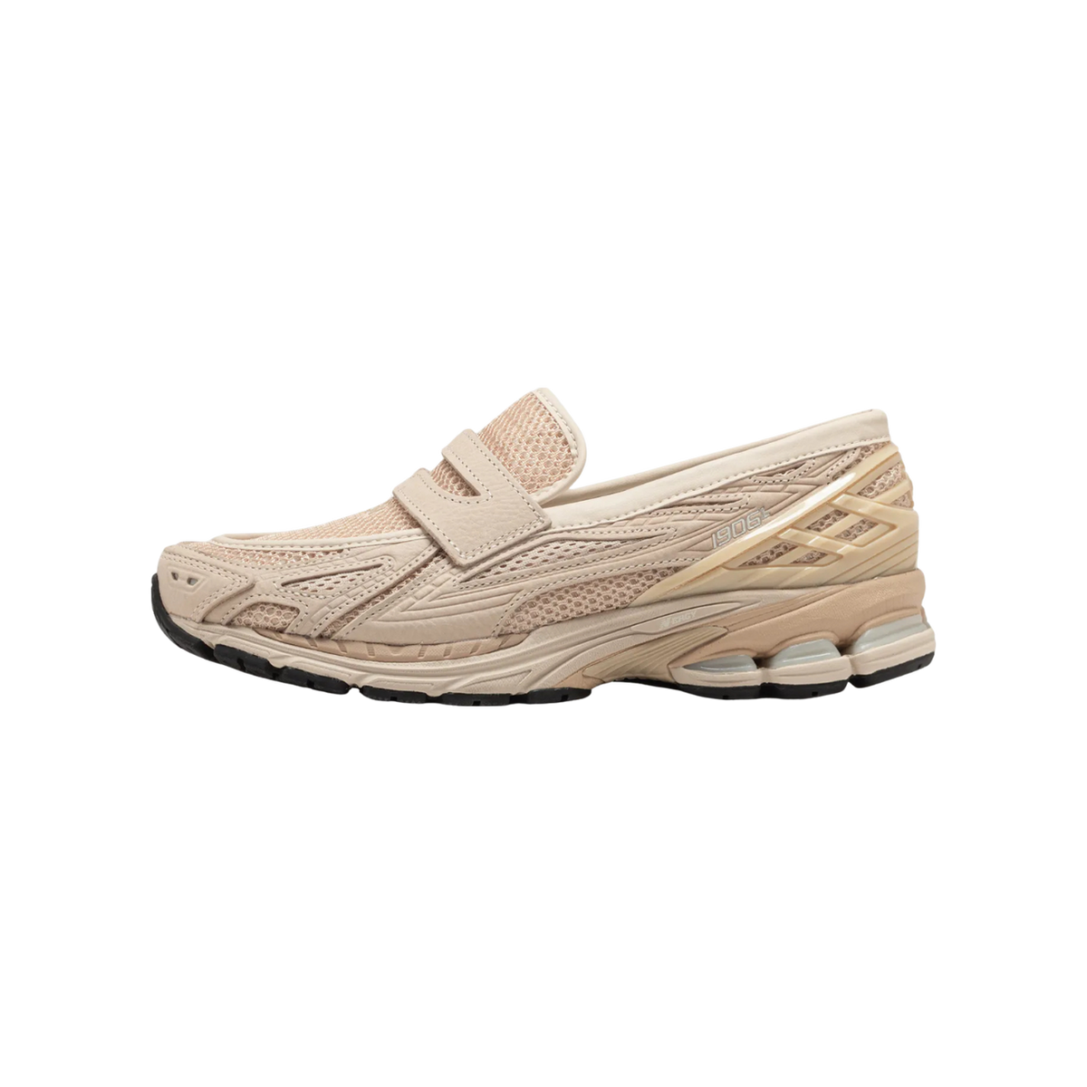 Side view of a beige New Balance 1906L sneaker with loafer-style strap, mesh overlays, and chunky layered midsole with black outsole.