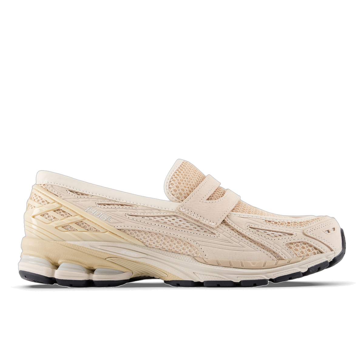 Side view of a beige New Balance 1906L slip-on sneaker with mesh panels, a velcro strap, and a chunky cream and black midsole, toe pointing left.