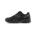 Side view of a black New Balance 1906R sneaker with silver N logo, red Primaloft tab, and a ridged black outsole, toe pointing left.