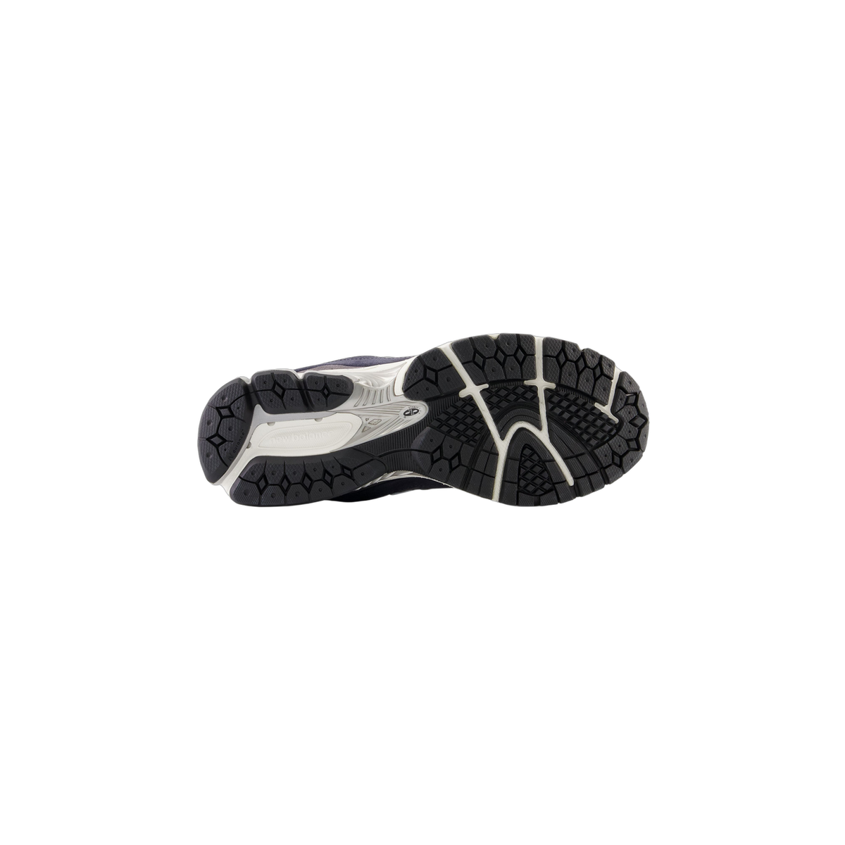 Bottom view of a New Balance 2002R sneaker showing the black and white tread pattern on the outsole with New Balance branding.