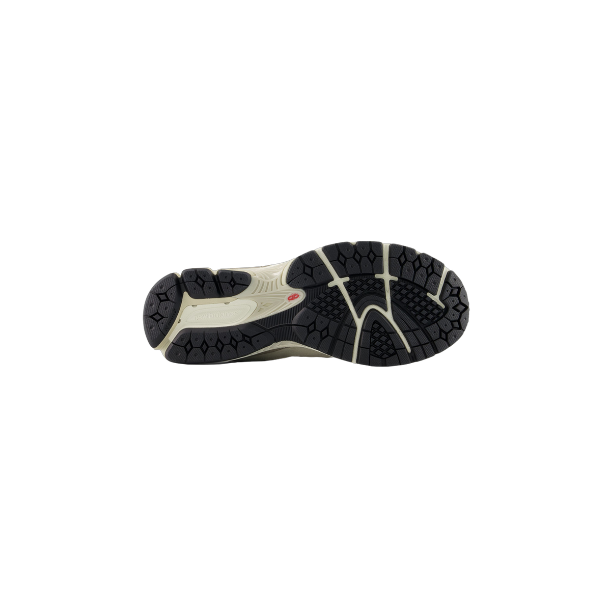 Bottom view of a New Balance 2002R sneaker showing the black lug tread pattern and beige midsole with the New Balance logo molded into the outsole.