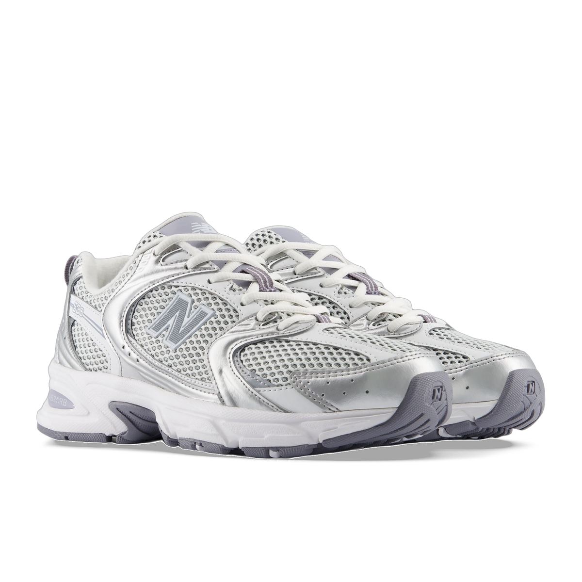 Angled front view of a pair of New Balance 530 sneakers in white and metallic silver with grey mesh panels and a gray N logo on each side.