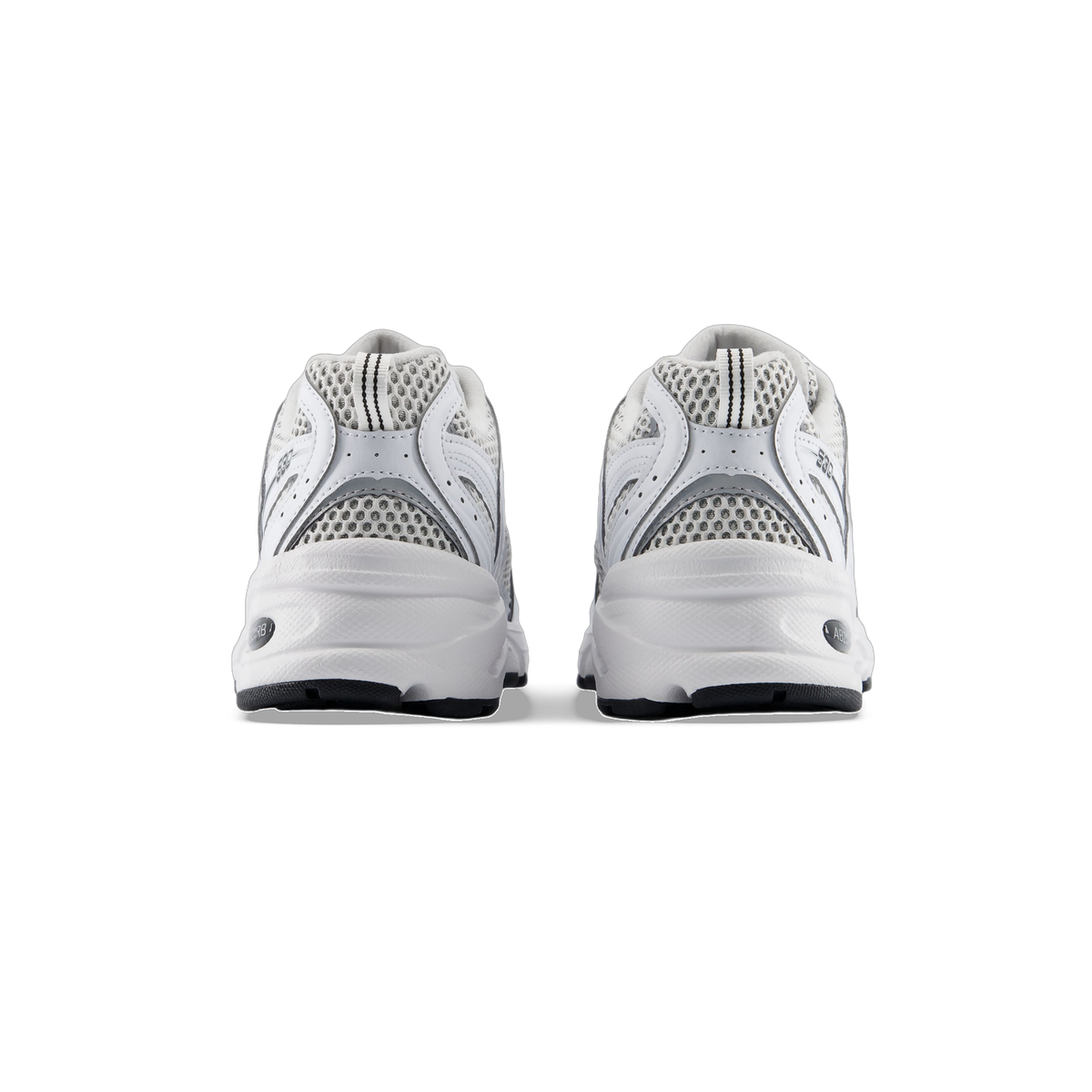 Rear view of a pair of white New Balance 530 sneakers with silver mesh panels and black outsoles, showing the 530 logo on each heel.