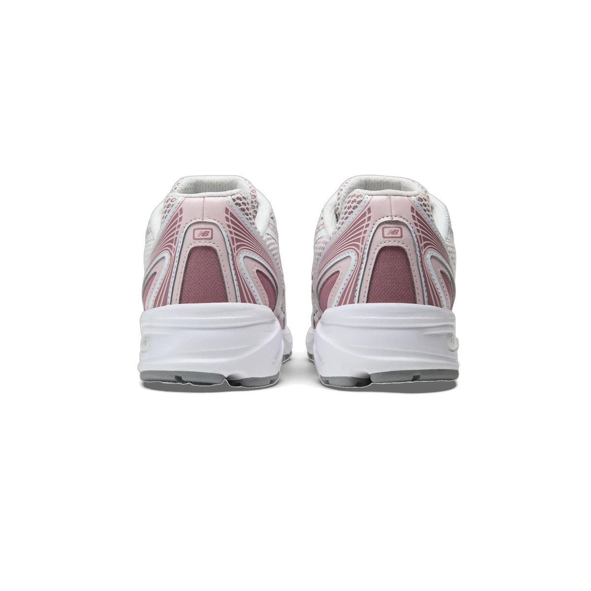 Rear view of a pair of New Balance 740 sneakers in white and pink tones with the New Balance logo on each heel and white midsoles.