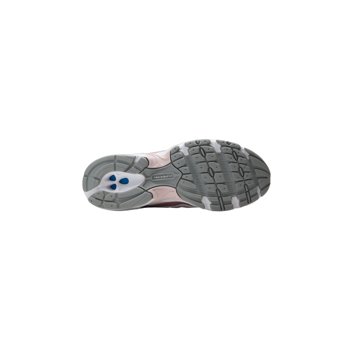 Bottom view of a New Balance 740 sneaker showing the gray tread pattern outsole with pink accents and New Balance branding at the arch