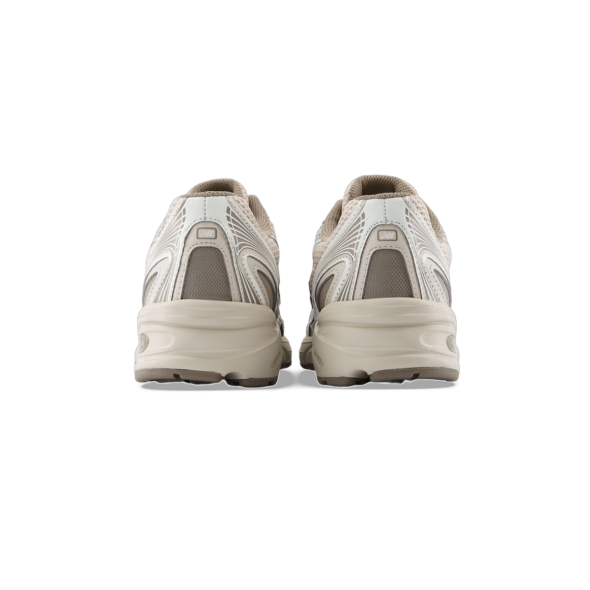 Rear view of a pair of beige New Balance 740 sneakers showing the heel counters with logo and chunky midsoles.