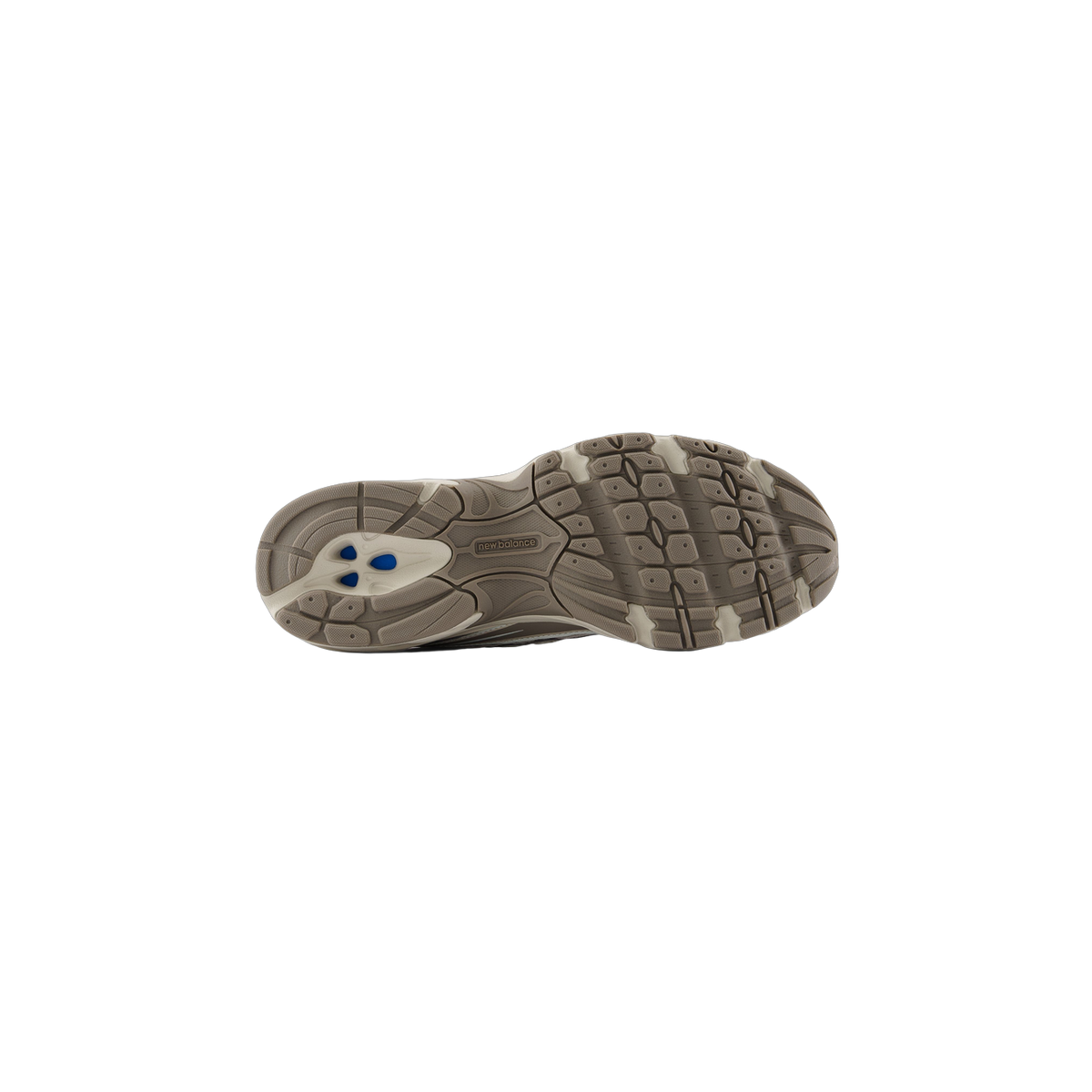 Bottom view of a New Balance 740 shoe showing the brown lugged outsole with New Balance logo and blue heel inserts