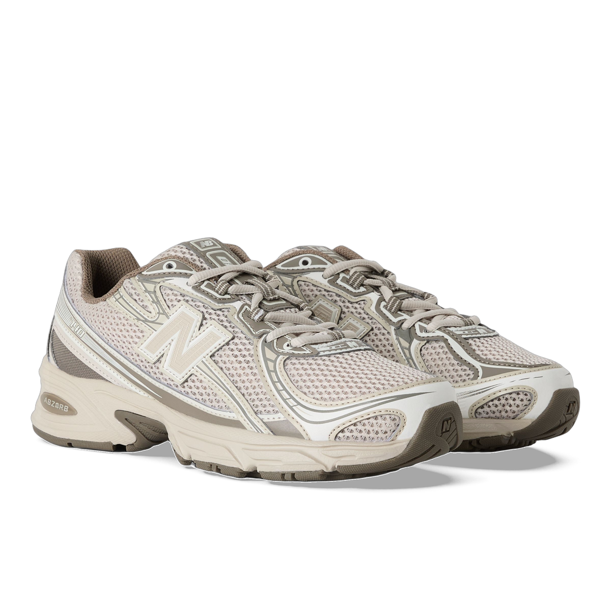 Pair of beige New Balance 740 sneakers with mesh uppers, grey overlays, and chunky ABZORB midsoles shown at an angled front view.
