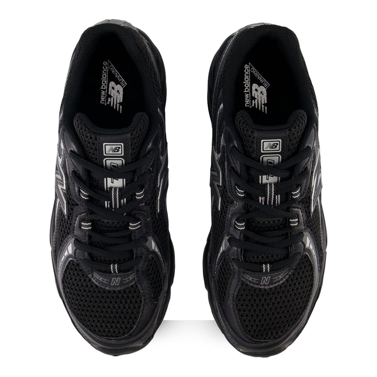 Top-down view of a pair of black New Balance 740v2 sneakers with silver N logos and mesh uppers, laces visible on a white background.