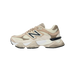 Side view of a beige and cream New Balance 9060 sneaker with tan suede overlays, black N logo, and chunky white and tan midsole.